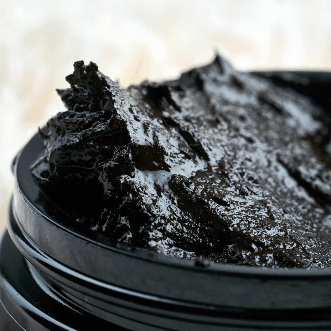 Close-up texture of peat mud—the key ingredient in Sphagnum Botanicals PsoriAid Peat Mud Shampoo; mineral-rich and soothing for sensitive scalps.