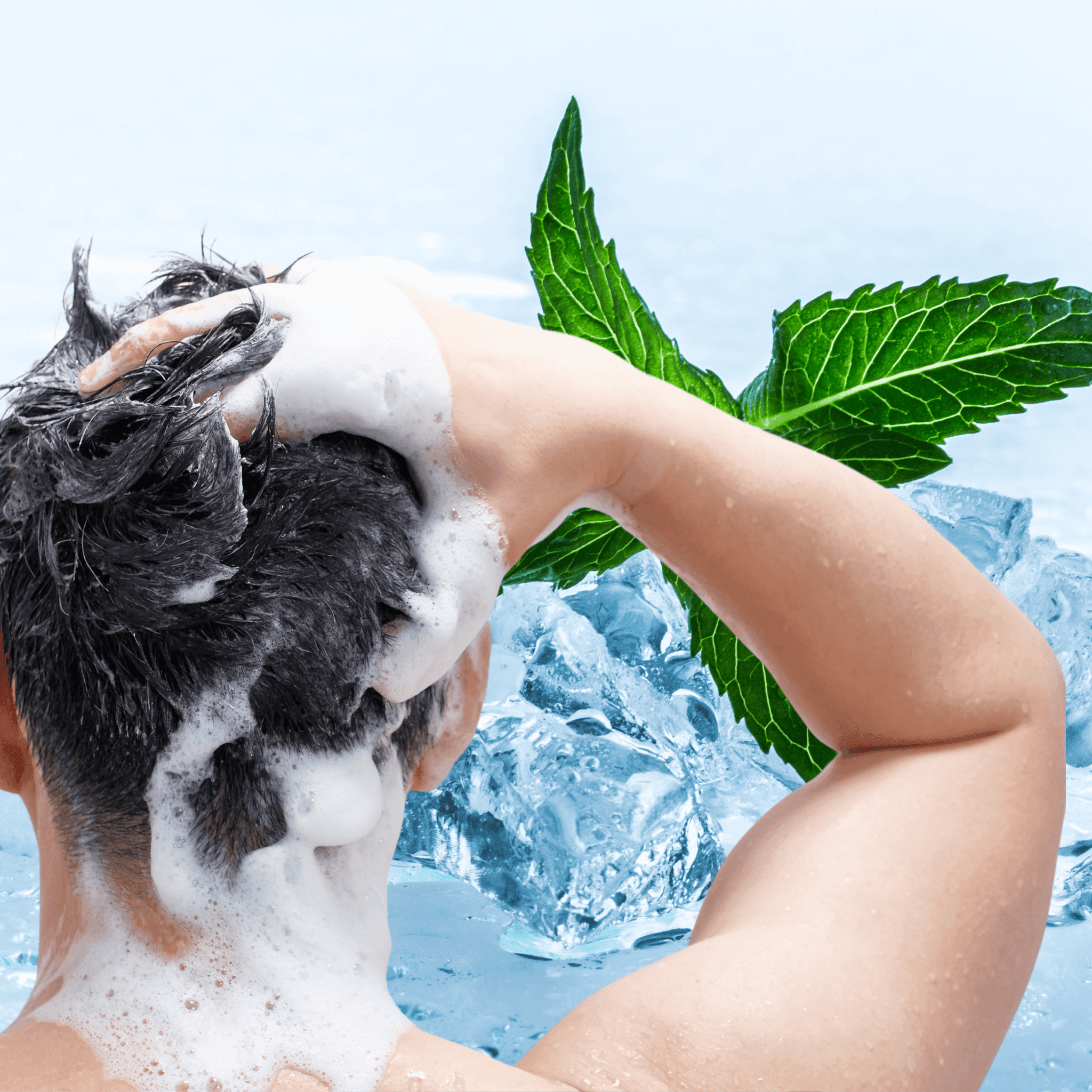 Man washing his foaming hair with hands; mint leaves and ice in the background suggesting fresh, cool sensation