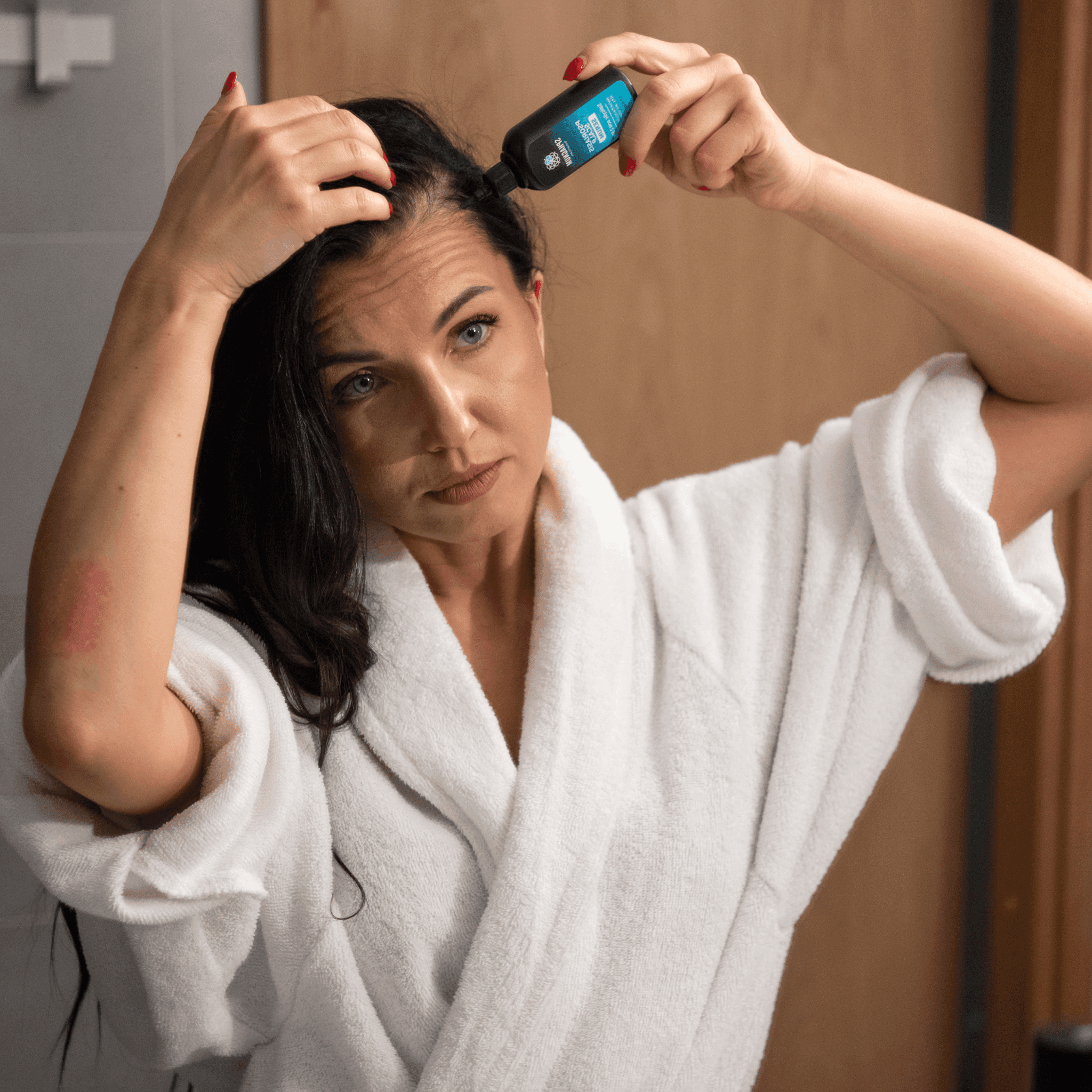 Woman applying psoriasis scalp serum to dandruff-prone itchy scalp for soothing relief and flake reduction.